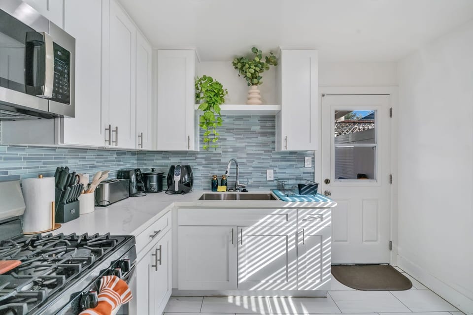 
A spacious full kitchen with modern appliances, ample counter space, and style.