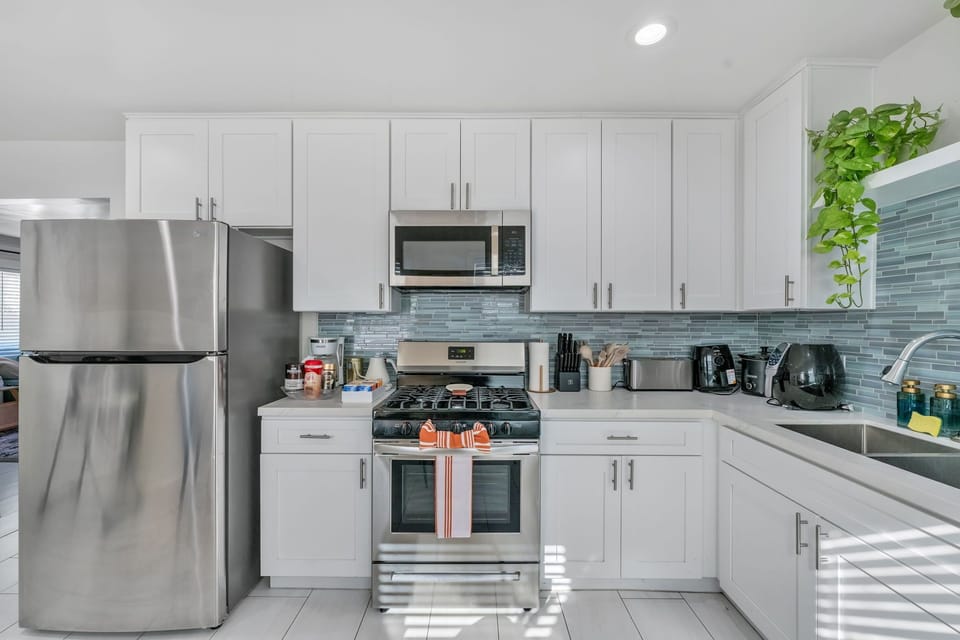 
A spacious full kitchen with modern appliances, ample counter space, and style.