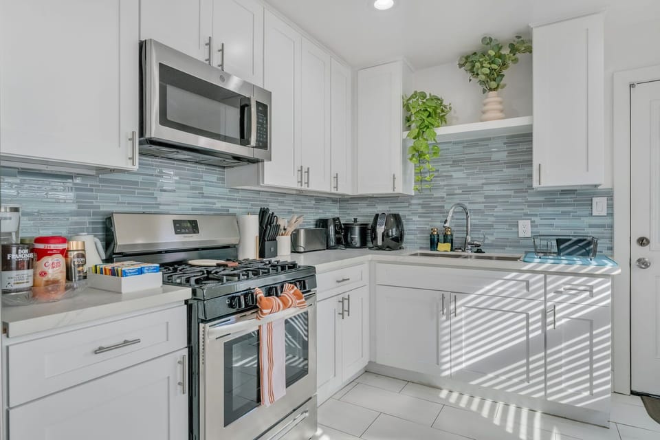 
A spacious full kitchen with modern appliances, ample counter space, and style.