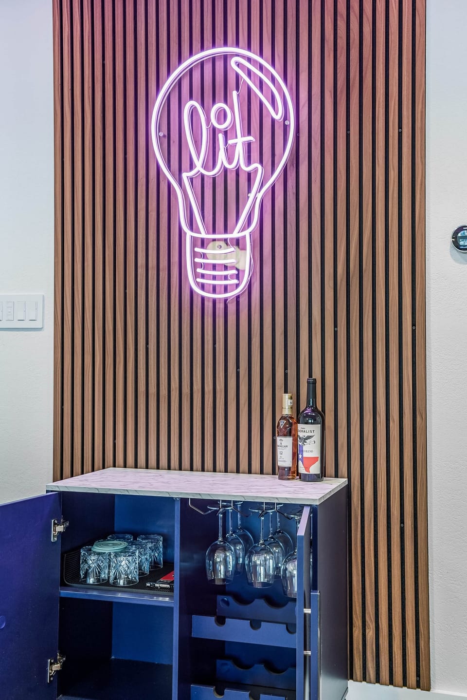 Bar cabinet is host-ready, complete with glassware for both wine and cocktails.