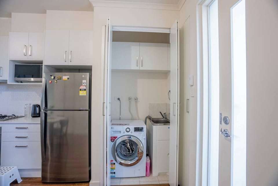 Laundry facilities add to your everyday convenience with a washing machine and basin.
