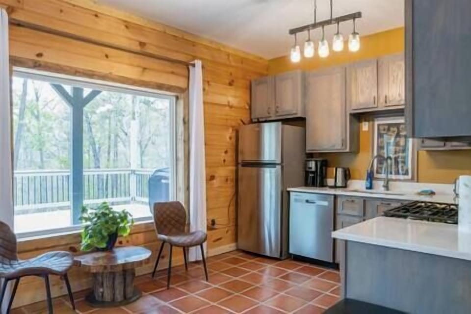 A well equipped kitchen with French doors leading out to the deck and grill.