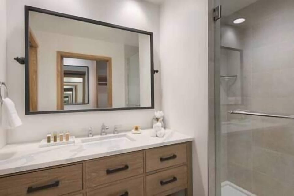 Refresh effortlessly with a sleek vanity and glass shower.