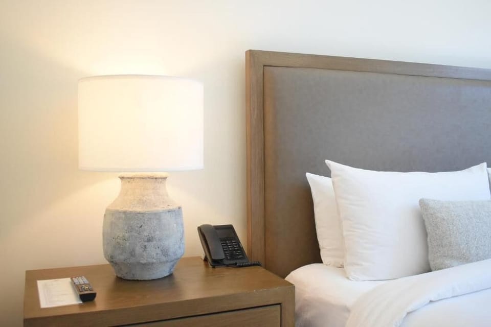 Wind down with soft lamplight and bedside essentials within reach.