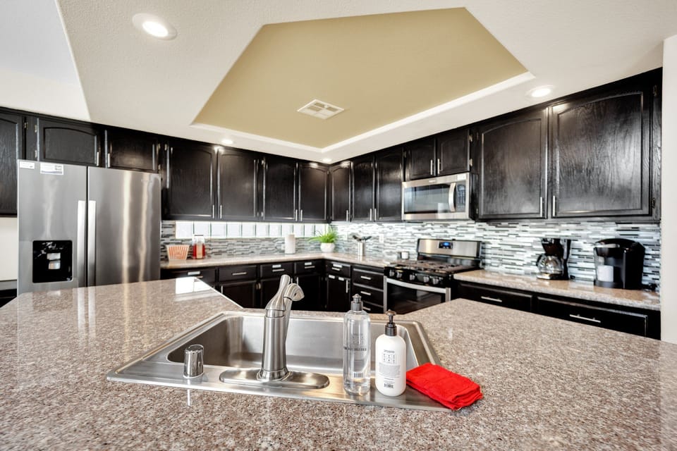 With sleek granite countertops, top-of-the-line stainless steel appliances, and ample cabinet space, this kitchen has everything you need to prepare meals, from a quick breakfast to a gourmet dinner.