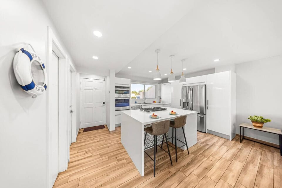 Open-plan kitchen with modern appliances, a central island, and stylish decor.