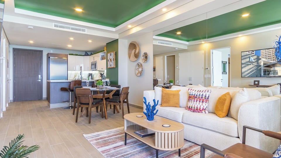 The main room with dining table, kitchen, and living room.