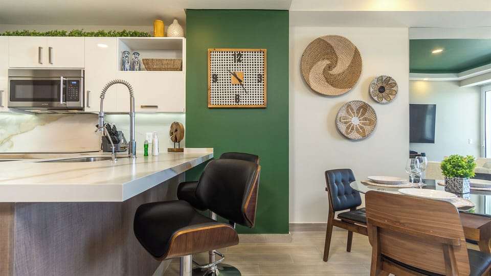 Swivel bar stools at the kitchen counter, next to the dining table.