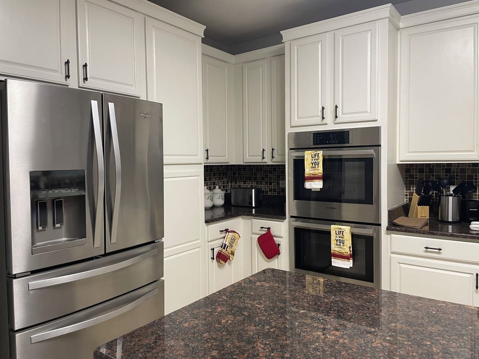 Full size fridge, ovens, and microwave in full kitchen