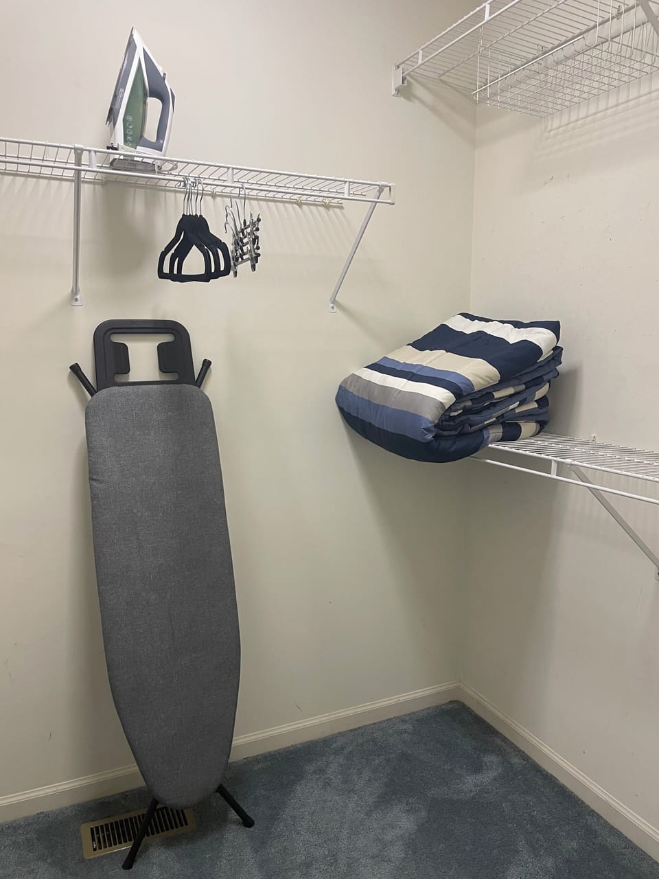 Ironing board and iron in walk in closet