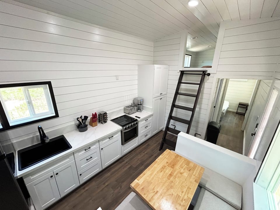 Full kitchen with sink, stove, refrigerator, coffee maker, and a great view
