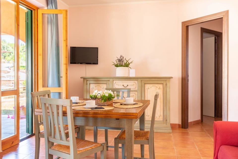 Nice three-room apartment in typically Tuscan style on the ground or first floor of approximately 50 m2 located in the area around the swimming pools.It is composed of a living room with dining area, flat-screen television and sofa bed, kitchenette equip Apartment in Tuscany