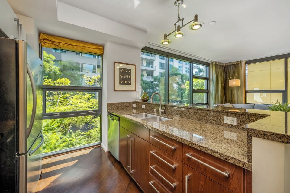 Kitchen has breakfast bar and granite countertops.