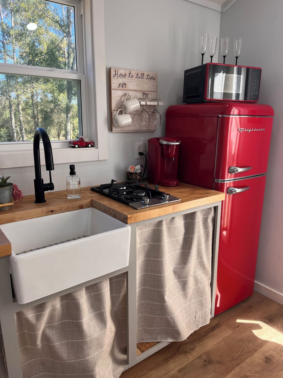 Kitchen with refrigerator, kurig, gas stove, and sink.