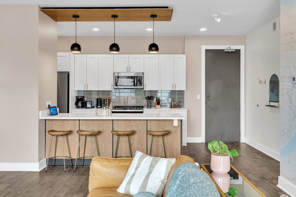Modern kitchen w/ breakfast bar seating — perfect for casual morning bites.
