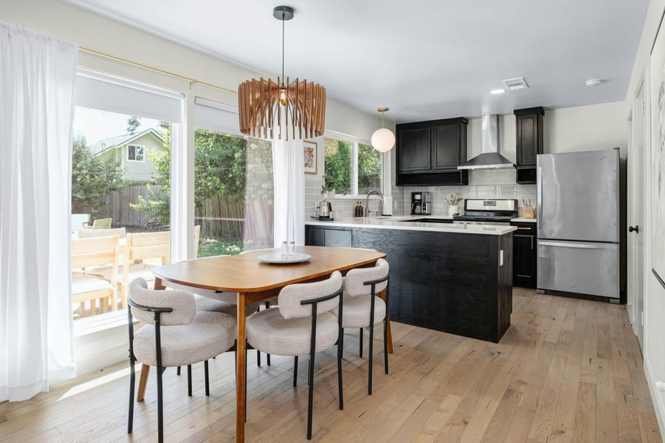 This mid-century dining room table comfortably seats 6, but has the option to extend with a leaf to accommodate 8, making it perfect for hosting intimate dinners or larger gatherings with friends and family. New chandelier photos coming soon! 