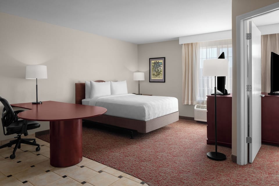 Unwind in a spacious suite with crisp linens and light.