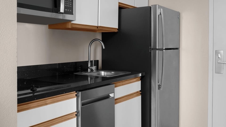 Enjoy easy meals with fridge, microwave, and sleek countertop space.