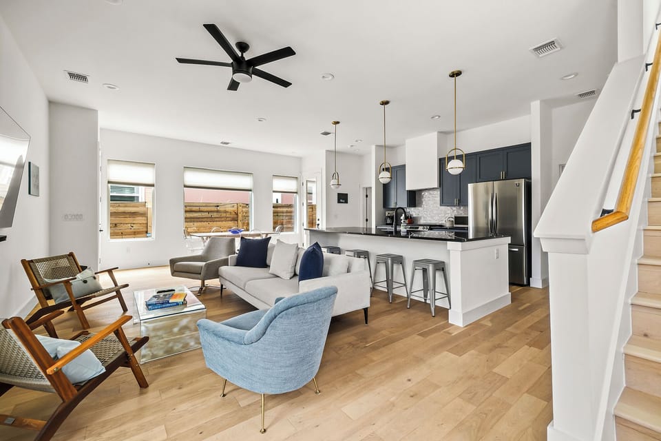 Flanking the main couch are two single chairs, complemented by two additional stylish chairs.