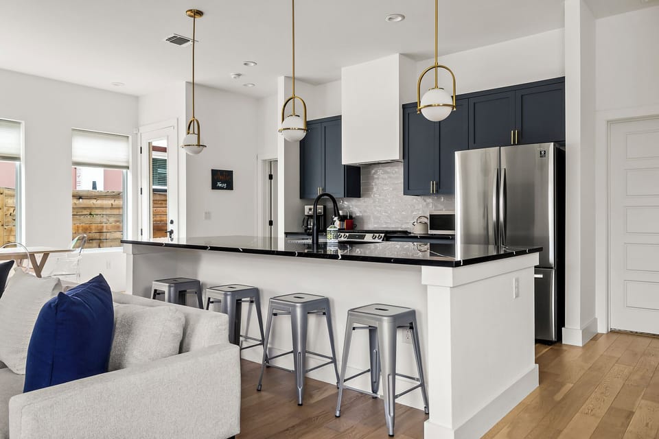 A spacious kitchen island with seating for six. A sleek 2-door fridge completes the setup, ensuring you have everything necessary for both everyday meals and entertaining.