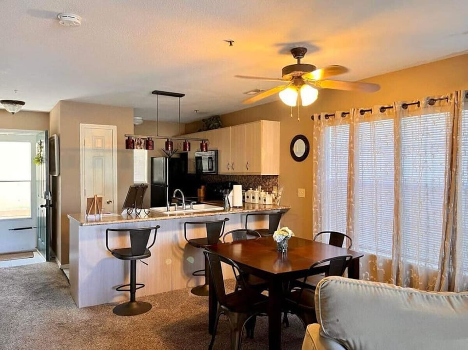 Serve your delicious meals easily at the lovely dining table and bar area.
