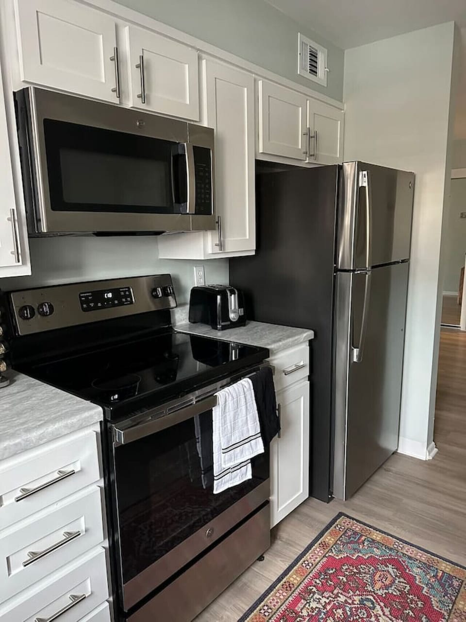 Modern Kitchen with refrigerator for your microwave, stove and oven for tasteful meals.