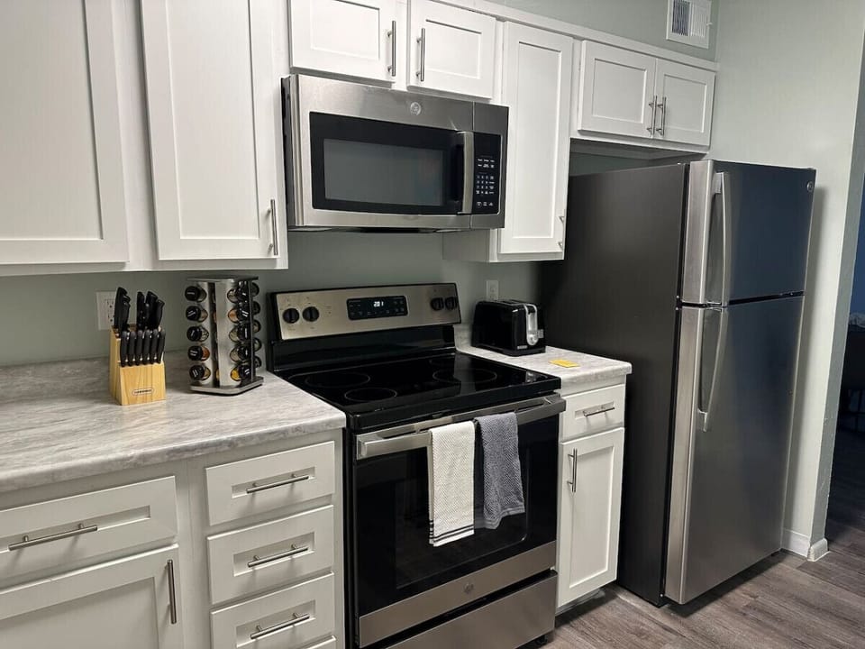 Fully Equipped kitchen with refrigerator for your perishables, oven, stove and microwave  for making delicious meals.
