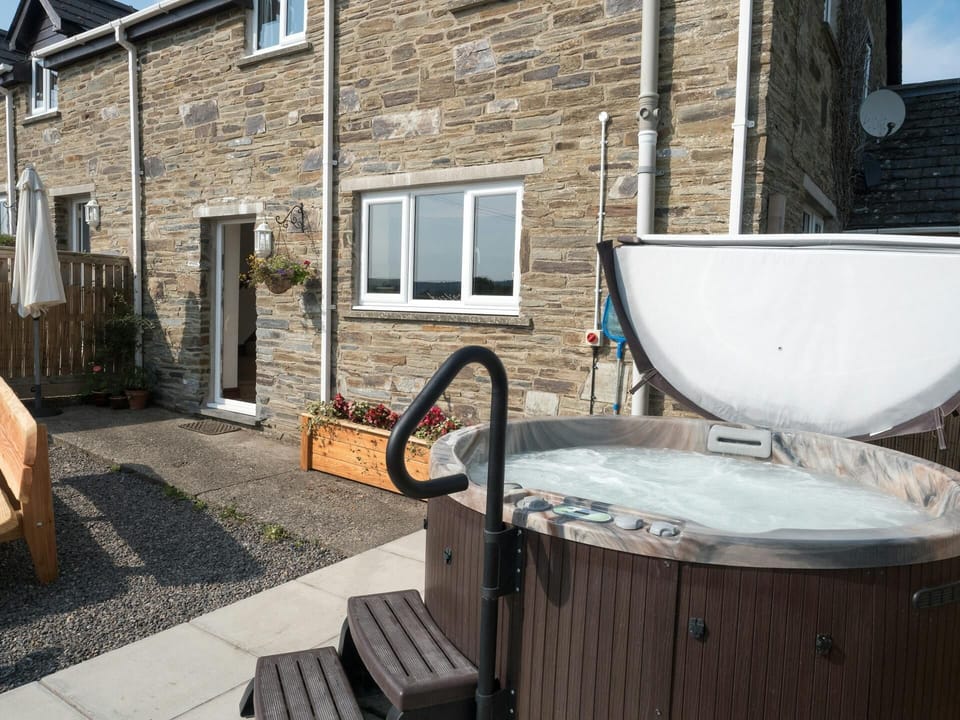 Outside of Elmtree Cottage with hot tub