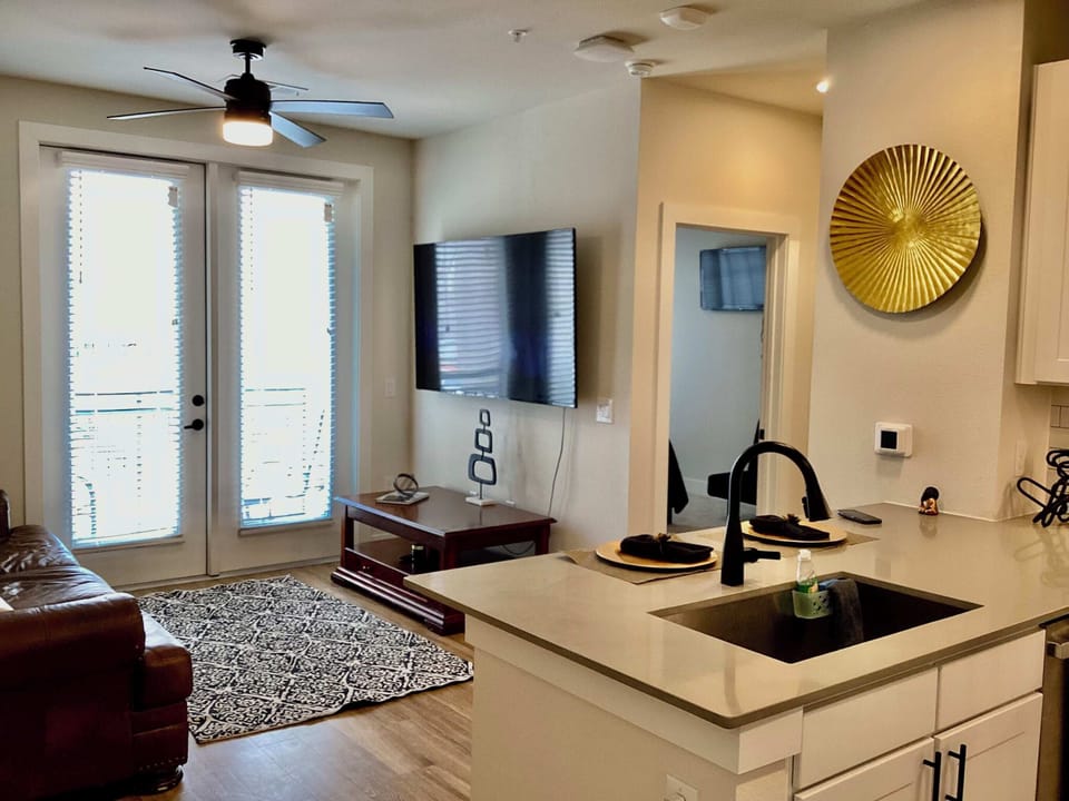 Living room with leather sofa, Smart TV and balcony 