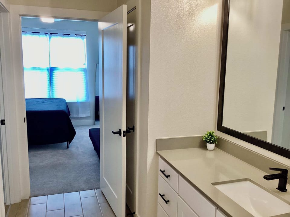 Bedroom with king bed, twin futon, Smart TV, and ensuite