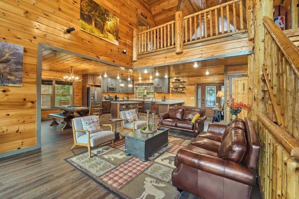This stunning open-concept cabin features a spacious living room, fully equipped kitchen & dining area, all under soaring vaulted ceilings. Cozy leather seating, rustic charm & modern touches create the perfect space for gathering & making memories!