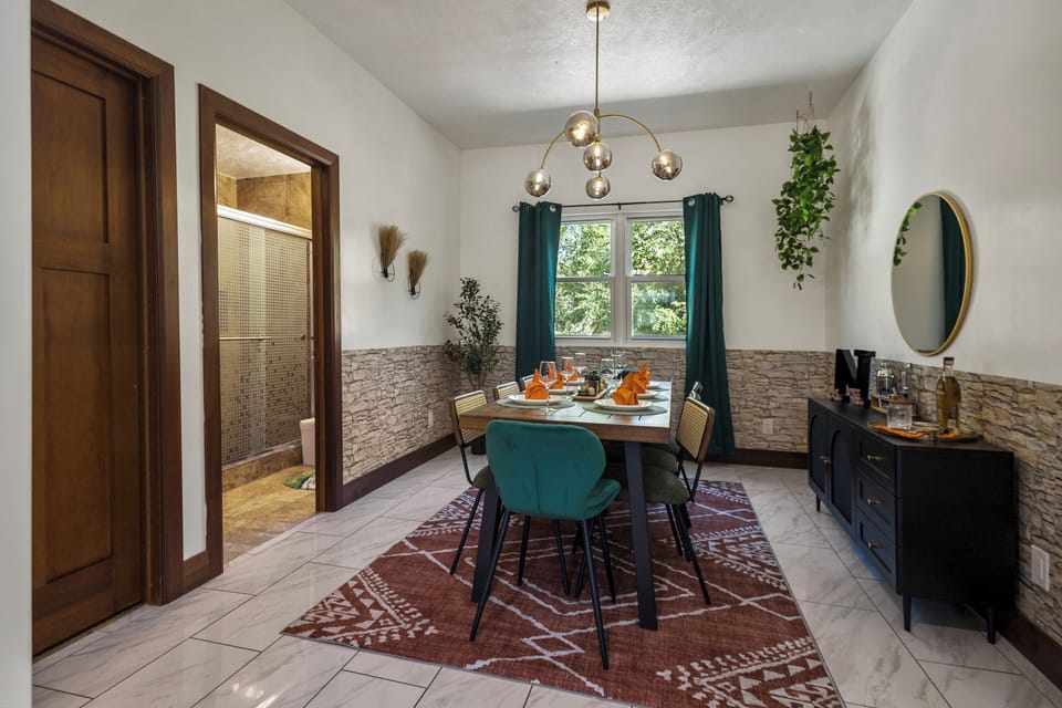 A bathroom is next to the dining area 