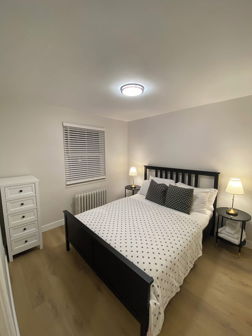 Second bedroom with queen bed, dresser and closet.