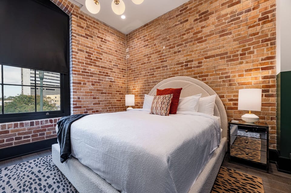 Retreat to the Primary bedroom with a plush king bed, walk-in closet, blackout shades, and a smart TV. Designed for comfort and privacy, this suite is perfect for recharging after a day exploring New Orleans.