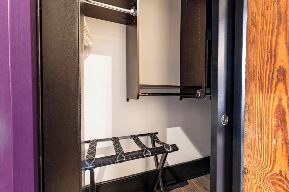 The second bedroom offers a cozy queen bed, dresser, smart TV, and soft linens. Great for families or friends traveling together, this room combines comfort and privacy in the heart of Downtown New Orleans.