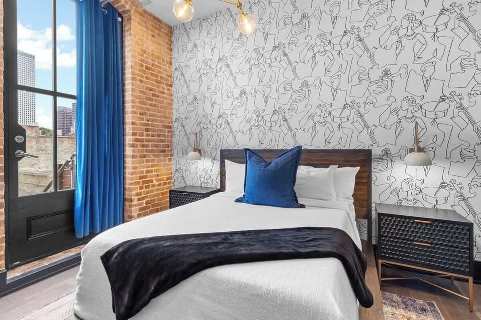 The second bedroom offers a cozy queen bed, dresser, smart TV, and soft linens. Great for families or friends traveling together, this room combines comfort and privacy in the heart of Downtown New Orleans.