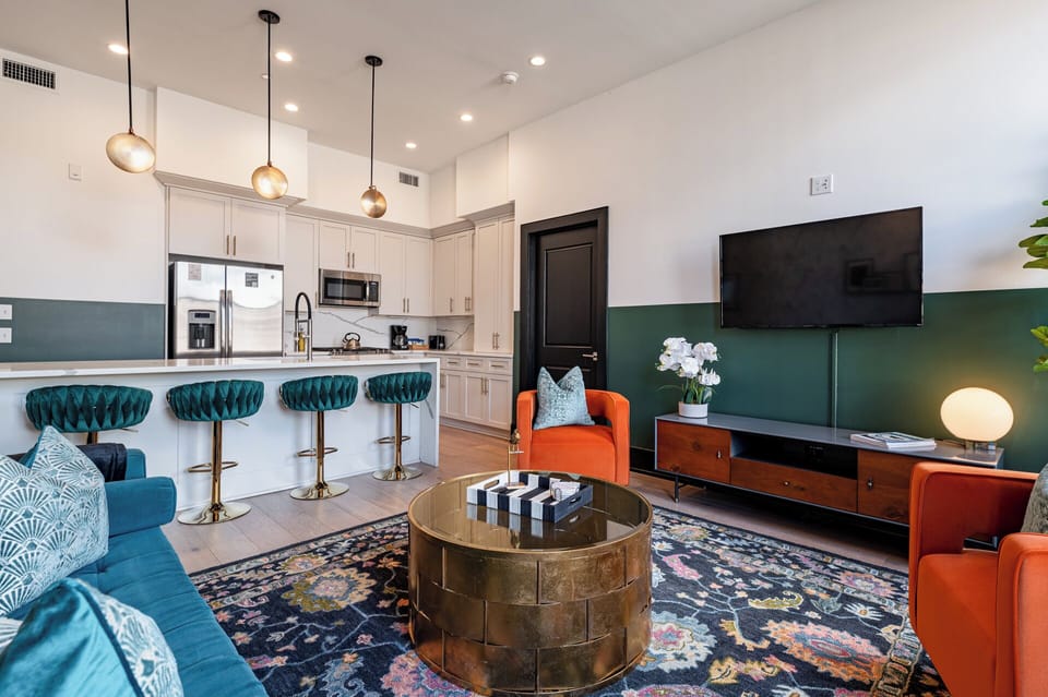 Relax in the living area with a smart TV, stylish seating, and a sleeper sofa for extra guests. Perfect for families or group stays in New Orleans, this inviting space is ideal for movie nights or recharging after a day in the city.