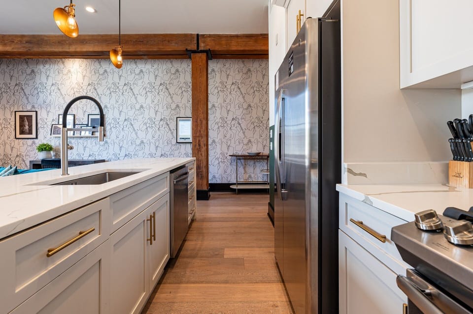 Cook or snack in style with a full kitchen featuring GE stainless appliances, cookware, and an island with bar seating. Ideal for short or extended stays, our kitchens make group travel in New Orleans easy and comfortable.