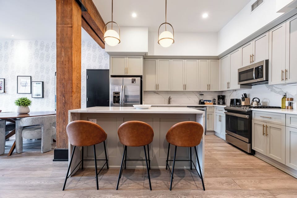 Cook or snack in style with a full kitchen featuring GE stainless appliances, cookware, and an island with bar seating. Ideal for short or extended stays, our kitchens make group travel in New Orleans easy and comfortable.