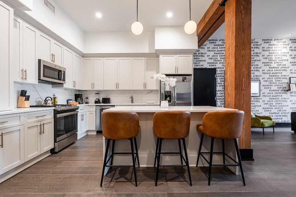 Cook or snack in style with a full kitchen featuring GE stainless appliances, cookware, and an island with bar seating. Ideal for short or extended stays, our kitchens make group travel in New Orleans easy and comfortable.
