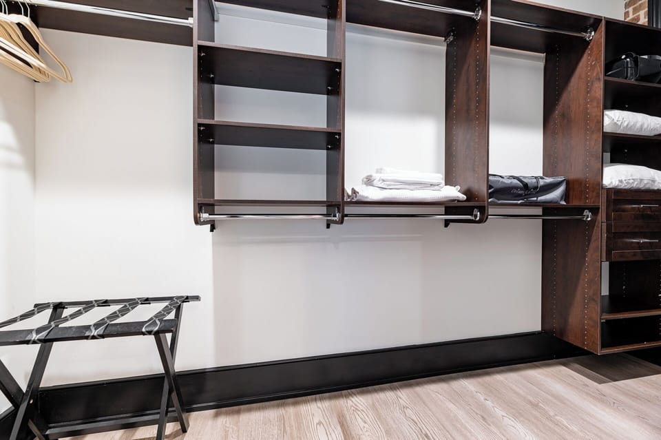 Retreat to the Primary bedroom with a plush king bed, walk-in closet, blackout shades, and a smart TV. Designed for comfort and privacy, this suite is perfect for recharging after a day exploring New Orleans.