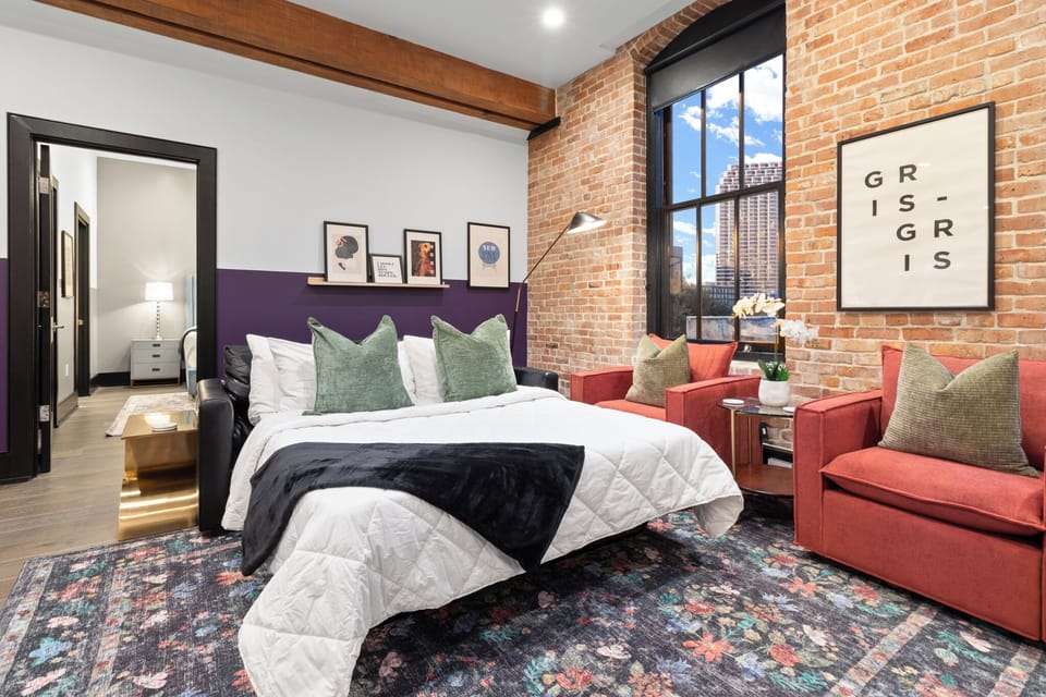 Relax in the living area with a smart TV, stylish seating, and a sleeper sofa for extra guests. Perfect for families or group stays in New Orleans, this inviting space is ideal for movie nights or recharging after a day in the city.