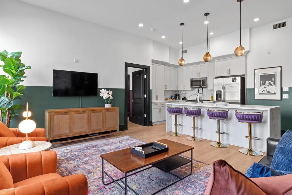 Relax in the living area with a smart TV, stylish seating, and a sleeper sofa for extra guests. Perfect for families or group stays in New Orleans, this inviting space is ideal for movie nights or recharging after a day in the city.