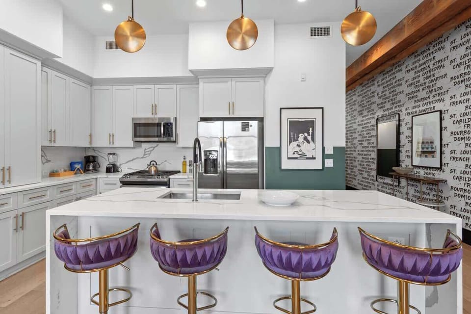 Cook or snack in style with a full kitchen featuring GE stainless appliances, cookware, and an island with bar seating. Ideal for short or extended stays, our kitchens make group travel in New Orleans easy and comfortable.
