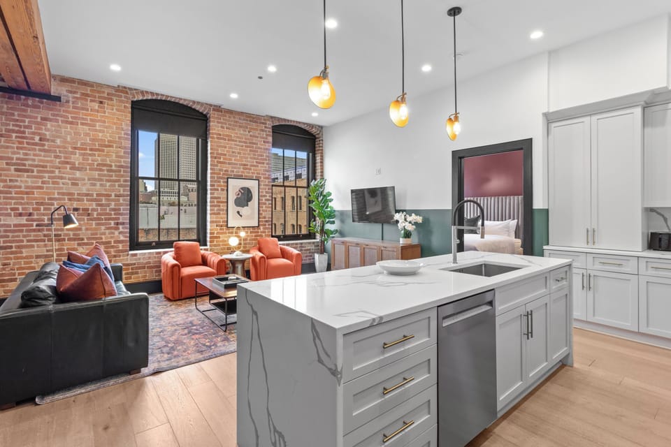 Cook or snack in style with a full kitchen featuring GE stainless appliances, cookware, and an island with bar seating. Ideal for short or extended stays, our kitchens make group travel in New Orleans easy and comfortable.