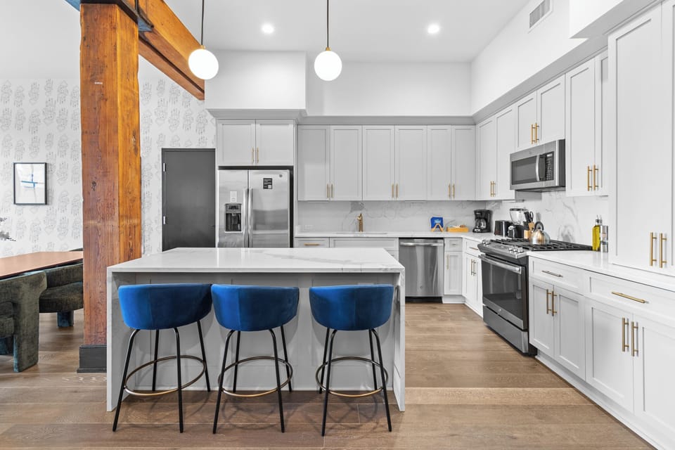 Cook or snack in style with a full kitchen featuring GE stainless appliances, cookware, and an island with bar seating. Ideal for short or extended stays, our kitchens make group travel in New Orleans easy and comfortable.