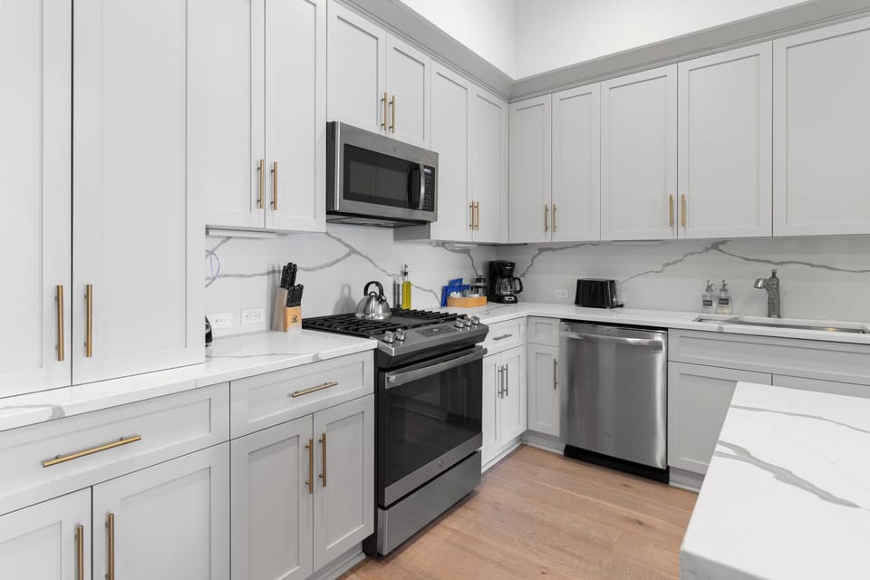 Cook or snack in style with a full kitchen featuring GE stainless appliances, cookware, and an island with bar seating. Ideal for short or extended stays, our kitchens make group travel in New Orleans easy and comfortable.