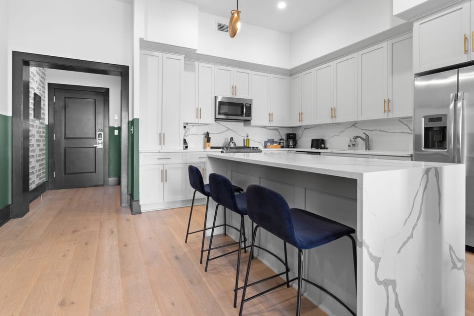 Cook or snack in style with a full kitchen featuring GE stainless appliances, cookware, and an island with bar seating. Ideal for short or extended stays, our kitchens make group travel in New Orleans easy and comfortable.