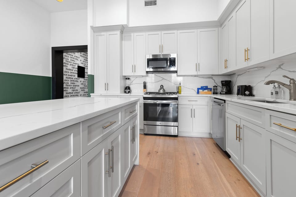 Cook or snack in style with a full kitchen featuring GE stainless appliances, cookware, and an island with bar seating. Ideal for short or extended stays, our kitchens make group travel in New Orleans easy and comfortable.