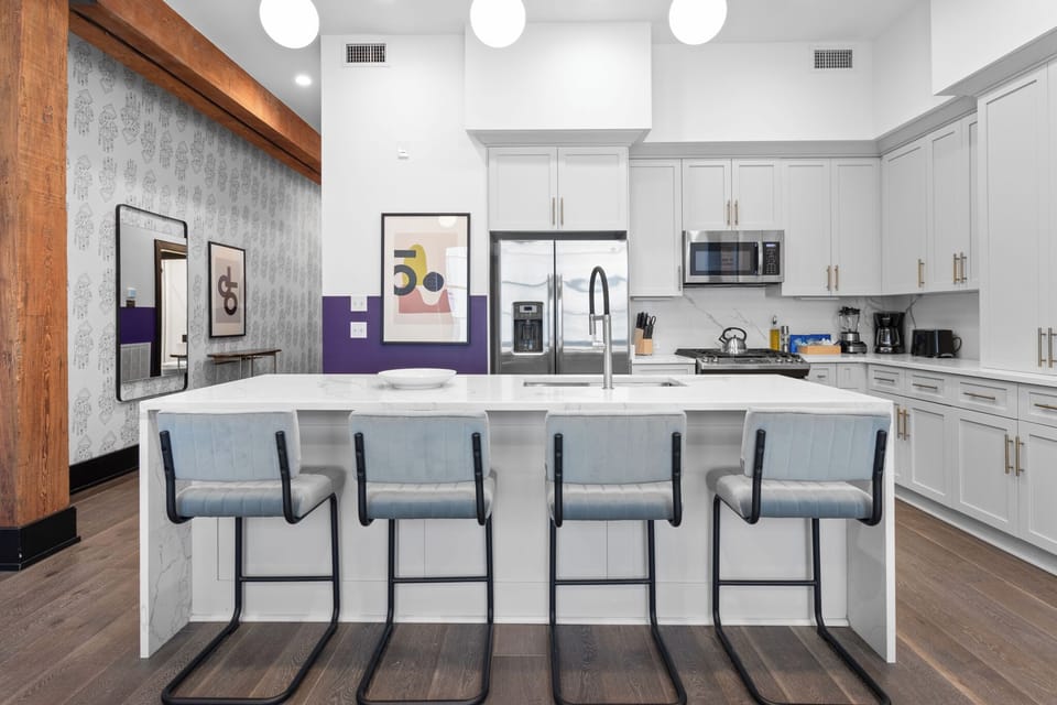 Cook or snack in style with a full kitchen featuring GE stainless appliances, cookware, and an island with bar seating. Ideal for short or extended stays, our kitchens make group travel in New Orleans easy and comfortable.